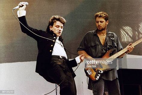 Photo of Adam CLAYTON and BONO and LIVE AID and U2 Bono Adam Clayton performing live onstage at Live Aid U2 80s, U2 The Unforgettable Fire, Paul Hewson, Bob Geldof, Bono U2, Live Aid, Adam Clayton, Roger Waters, Looking For People