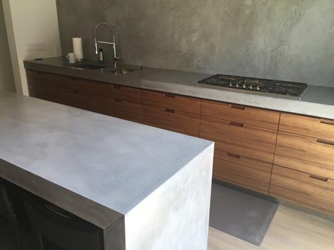 Concrete kitchen countertops with waterfall edge Concrete Tile Kitchen, Concrete Waterfall Countertop, Fiji House, Plywood Office, Kitchen Countertops Concrete, Concrete Kitchen Countertops, Black Kitchen Table, Waterfall Countertop, Window Seat Kitchen