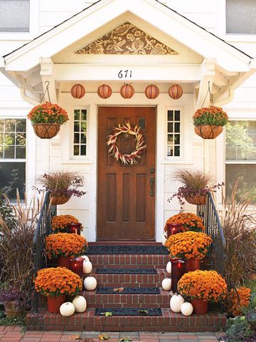 Curb Appeal: Lush potted mums add color to this front stoop, as do paper lanterns hung from the portico. White pumpkins add contrast and a harvest wreath defines the solid wood door. Fall Landscaping, Fall Front Porch Ideas, Front Stoop, Small Ideas, Entry Decor, Small Wreaths, Porte Decorate, Autumn Decorating, Fall Front Porch