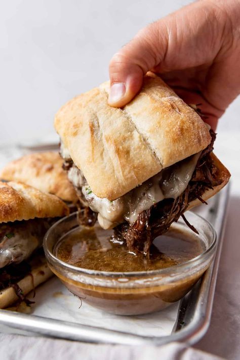 These toasty Slow Cooker French Dip Sandwiches are made with slow cooked roast beef served on crusty rolls with melty cheese and savory au jus. The prep is less than 15 minutes and then the crockpot does all the work for you. These are so good! #frenchdip #sandwiches #slowcooker #crockpot #instantpot #best #easy #shredded #beef #dinner Slow Cooked Roast Beef, Slow Cooker French Dip Sandwiches, Slow Cooker French Dip, Recipes French, French Dip Sandwiches, Dip Sandwiches, French Dip Sandwich, French Dip, Chapati