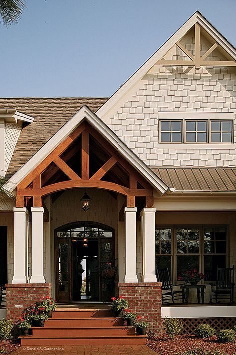 This rustic home has tons of curb appeal with gable brackets and columns framing the front porch. Plan #1125-D - The Cedar Ridge. #Rustic #Exterior #Details Peak Roof House, Timber Frame Entrance Front Entry, Roof Peak Accents Cedar, Porch Arch, Gable Detail, Timber Steps, Hardiplank Siding, Porch Gable, Cedar Porch