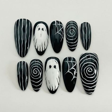 Get spooky with our White Ghost Illusion Halloween press-on nails! Featuring a striking black and white spider web design, these custom, reusable press-ons are perfect for adding a hauntingly stylish touch to your Halloween look. Embrace the season with these trendy, personalized nails. 🌸Thank you for supporting my small business.🌸 You can reuse all the nails you purchased from us multiple times, if you handle them with care 📦𝐖𝐡𝐚𝐭 𝐜𝐨𝐦𝐞𝐬 𝐰𝐢𝐭𝐡 𝐲𝐨𝐮𝐫 𝐩𝐫𝐞𝐬𝐬 𝐨𝐧 𝐧𝐚𝐢𝐥 𝐤𝐢 Black Silver Halloween Nails, Halloween 2024 Nail Art, Easy Spider Web Nail Art, Black Nails With Swirls, Simple Black And White Halloween Nails, Halloween Nails Long Stiletto, Spooky Press On Nails, Spider Web Halloween Nails, Halloween Gothic Nails