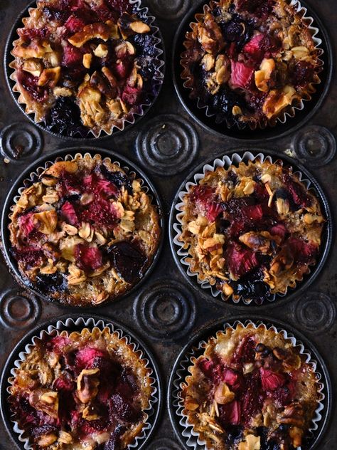 Baked oatmeal cups with lots of berries in a muffin tin. Oatmeal Cups Baked Breakfast Recipes, Granola Baked Oatmeal, Baked Oats In Muffin Pan, Baked Banana Oatmeal Cups, Nuts And Berries, Vegan Baked Oatmeal, Heidi Swanson, Sally’s Baked Oatmeal, 101 Cookbooks