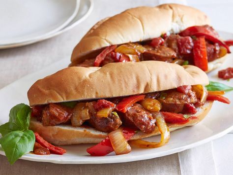 Giada's Sausage, Peppers and Onions : Not just for summertime carnivals, this go-to Italian sandwich is elevated with Giada's bold homemade sauce simmered with Marsala wine and a pinch of red pepper flakes. When it comes to serving, either tuck the thickened sauce with sausage, peppers and onions into chewy rolls, or spoon the dish into bowls. Sausage And Peppers Recipe, Sausage Peppers And Onions, Italian Street Food, Everyday Italian, Sausage Peppers, Sausage And Peppers, Giada De Laurentiis, Onion Recipes, Turkey Sausage