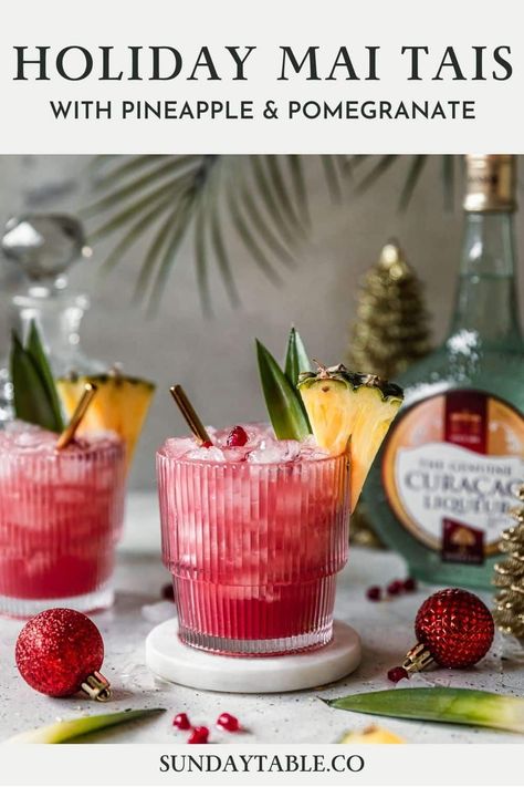 These holiday mai tais are perfect for Christmas and other winter holidays! This rum cocktail with pineapple juice, cranberry, lime, and Curacao liqueur is an easy, fun, creative, tropical drink for parties and the holidays. Use light, spiced, or dark rum depending on what you have. You can also make it in a pitcher for a crowd! Mai tais are a boozy, Hawaiian-inspired alcoholic drink but they're very drinkable and so good! If you need a Christmas drink for adults, your guests will love these. Holiday Cocktails Christmas, Simple Cocktails, Caribbean Christmas, Orange Cocktails, Christmas Drink, Tiki Drinks, Rum Cocktails, Festive Cocktails, Tropical Christmas