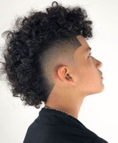 The Afro Hawk with a mid taper for black men is a dynamic hairstyle that combines the natural texture of an afro with the boldness of a mohawk. The Afro Hawk with a mid taper is not just a hairstyle; it's a statement, allowing black men to embrace their individuality with confidence and style. Afro Hawk, Frohawk Fade, Fade Curly Hair, Mid Taper, Short Sides Long Top, Man Haircuts, Curly Mohawk Hairstyles, Top Hairstyles For Men, Male Haircuts Curly