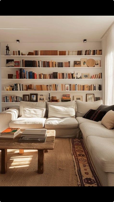 Stylish Minimalist Home, Living Room Designs Library, Floating Bookshelf Living Room, Shelving Unit Behind Couch, Library Wall Shelves, Living Room With Library Wall, Wall Library Ideas, Bookshelf Above Couch, Minimalistic Library