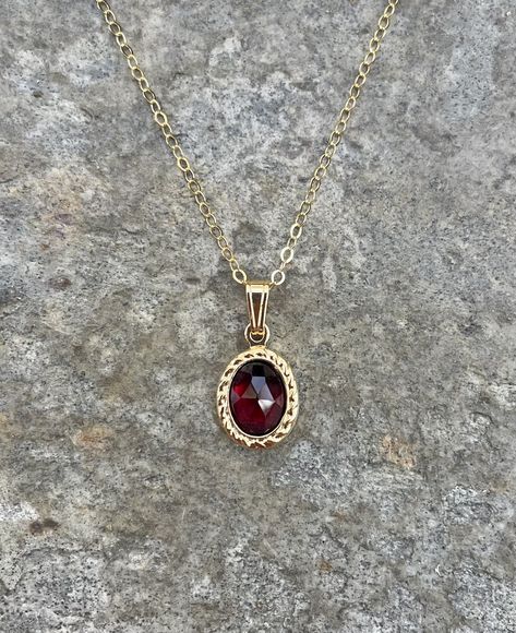 This necklace is handcrafted with an authentic 6x8mm garnet stone in a gold setting. The chain is 14k gold-filled and will not tarnish easily.  This necklace is hypoallergenic. (Cadium free, lead free, and nickel safe) Garnet is an energizing stone that promotes passion and love.  The necklace comes in a ribbon-wrapped box, ready to be gifted. If you would like to leave a note for the recipient, you can do so during checkout. Garnet Necklace Gold, Maroon Necklace, Red Crystal Necklace, Crystal Necklaces, Garnet Necklace, Dope Jewelry, Vintage Style Jewellery, Garnet Stone, Fancy Jewelry