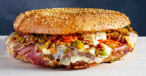 Layers of cured meats, provolone cheese, pickled giardiniera vegetables and olive salad make the muffuletta a standout sandwich. Muffaletta Sandwich, Muffuletta Sandwich, Olive Salad, Open Faced Sandwich, Chicken Curry Salad, Tomato Sandwich, Sloppy Joe, Tea Sandwiches, Sandwich Recipe