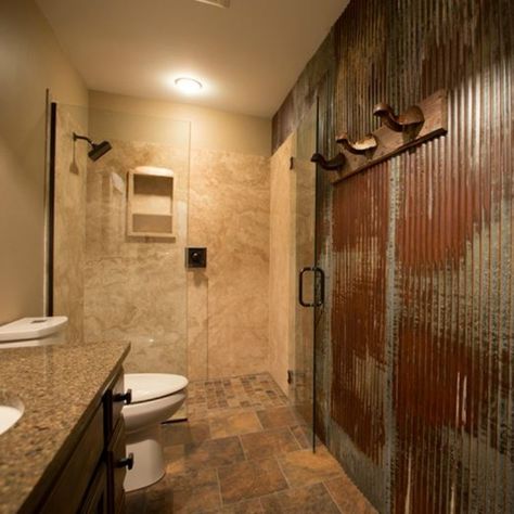 Totally rustic and rugged, this is definitely a bathroom fit for a man. From organically rusted steel walls and pounded steel mirror frame, to the faux weathered vanity and complementing light fixture, all in style and are perfect details on the earth toned tile on floor and natural stone shower wall panels. So much personality, you will forget this is an average size bathroom! Metal Shower Walls Corrugated Tin, Tin Bathroom Ideas, Corrugated Metal Bathroom, Metal Shower Walls, Tin Shower Walls, Tin Shower, Tin Bathroom, Rugged Man, Corrugated Metal Wall