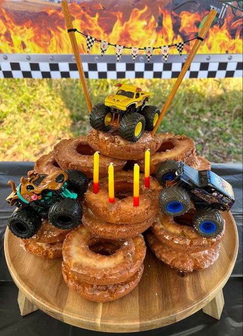 Monster Truck Donut Cake Monster Truck Donut Cake, Monster Truck Birthday Party Cake, Monster Truck Birthday Table Decor, Monster Jam Cake Pops, Monster Truck Balloons, Monster Jam Cupcakes, Monster Truck Cupcake Cake, Diy Monster Truck Cake, Truck Birthday Cake Ideas