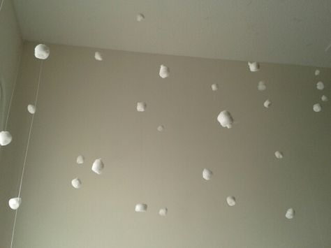 To make it look like falling snow, use a cotton ball and nylon, and hang it from the ceiling with tape. Snow Ceiling Decorations, Paper Snowflakes Hanging From Ceiling, Cotton Ball Snowflakes, Cottonball Snow Garland Diy, Snow Hanging From Ceiling, Snow In Summer, Christmas Props, Cotton Ball, Tis The Season