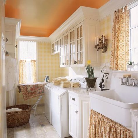 HGTV invites you to see this bright yellow laundry room that features and oversized farmhouse sink and cottage accessories. Cottage Accessories, Yellow Laundry, Cottage Laundry Room, Yellow Laundry Rooms, Laundry Room Paint Color, Traditional Laundry Room, Laundry Room Paint, Tudor Kitchen, Laundry Room Decorating