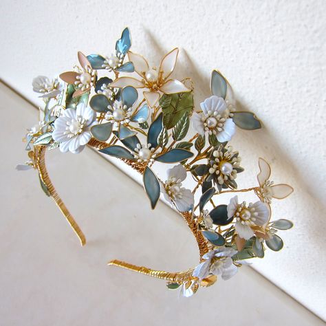 This handmade, gold-plated headdress is woven with mixed-media flowers, crystals and beading. Attach to the head by stringing provided elastic ribbon through loops at the back. The size is adjustable and the wires are malleable to create a variety of looks. Height at tallest point: 6cm Magpie Hoard, Tulle Crafts, Fascinator Hats Wedding, Blue White Weddings, Goddess Crown, Headband Crown, Medieval Wedding, Crown Gold, Bridal Headdress