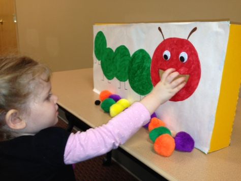 "The children had fun “feeding” the hungry caterpillar a variety of colors and sizes of pompoms. This encouraged even my little ones to recall the food from the story – they called the purple pompoms “plums,” the red ones were “apples,” etc." Insects Kindergarten, Caterpillar Art, Eric Carle Activities, The Very Hungry Caterpillar Activities, Hungry Caterpillar Craft, Hungry Caterpillar Activities, Bugs Preschool, Caterpillar Craft, Hungry Caterpillar Party