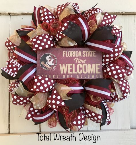 This Florida State University wreath is a must have for “NOLES” fans!!  This wreath is created by using deco mesh and wired ribbon all using FSU colors.  A wooden “Florida State Fans Welcome” sign is located in the center of the wreath to complete the look.    Show your team spirit by displaying this wreath on your front door, office door, or any room in your home all year!  Approximate size is 24” x 6”. College Wreaths For Front Door, Football Team Wreaths, College Wreaths, Wall Wreath Decor, College Crafts, Door Office, Deco Mesh Wreaths Diy, Door Hangings, Fun Wreath