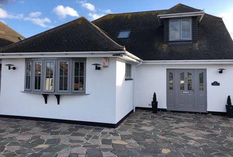 UPVC window and door respray in light grey.   We had a great time transforming this bungalow with a full UPVC respray. Book an appointment with us today and see how we can help with your project. #newhome #homeimprovement #renovation #myfirsthome #respray Less White And Grey Bungalow Exterior, Seaside Bungalow Exterior, Light Grey Upvc Windows, Grey Pvc Windows, Grey Bungalow Exterior, White House Grey Windows, Light Grey Windows Exterior, Scandi Bungalow, Bungalow Render