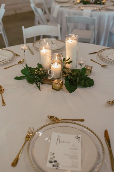 Gold rimmed plates with matching gold flatware, candles and greenery provided a delicate and classy wedding table decor. This was a dreamy wedding at our white barn wedding venue in North Georgia. See more from this beautiful wedding in Auburn, Georgia. White Gold And Greenery Wedding, Classy Barn Wedding, Gold Wedding Table Decorations, Dinner Party Table Settings, Vintage Wedding Table, Candle Wedding Centerpieces, Farm Wedding Venue, Wedding Cake Table, Boho Wedding Decorations