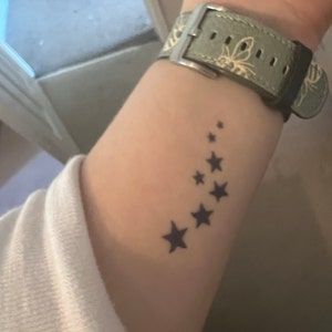 stars Star Tattoos Black Women, Star Wrap Around Tattoo, 3 Stars Tattoo, Black Star Tattoo, Star Tattoo On Wrist, Night Tattoo, Wrap Around Tattoo, Stars Tattoo, Tattoo Board