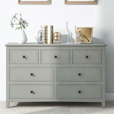 This chic dresser, made from sturdy pine solids and MDF boards, is a combination of style and functionality. It comes with ample storage space to hold a variety of items, from clothes to accessories. The piece features brushed nickel hooded pulls, solid tapered wood legs that add a touch of sophistication, and a paint-coated, water-resistant surface for longevity and easy maintenance. Its classic color effortlessly complements your existing furniture, bringing a pleasing visual experience to you Lingerie Dresser, Dresser Wood, Chest Of Drawers Bedroom, Storage Solutions Bedroom, Small Dresser, Solid Wood Dresser, Grey Storage, 7 Drawer Dresser, Drawer Design