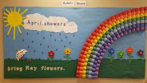 "April showers bring May flowers "bulletin board. The rainbow is made with stapled paper loops and the flowers are hot glued milk lids. Flowers Crafts Preschool, April Bulletin Board Ideas, Flowers Bulletin Board, Flower Bulletin Boards, April Bulletin Boards, Flower Crafts Preschool, Rainbow Bulletin Boards, Holiday Bulletin Boards, Halloween Bulletin Boards