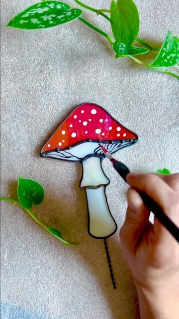 Lundy Glass • Stained Glass Art on Instagram: "🍄✨Amanita Muscaria plant stake ✨🍄 Lately I've really enjoyed glass painting! I've been working my hands to the bone preparing for the upcoming festival, so it's nice to have little relaxing moments like this 😌🎨 (That festival would be the Hop n' Barley this Saturday~ see my beer hop post for more info!✨) •Mushroom & moon plant stakes will be available in the shop 7/11! . . . . . . . . . . . #stainedglass #glassart #stainedglassmushroom #mushroom Stained Glass Mushroom Plant Stake, Amanita Mushroom, Mushroom Stained Glass Art, Stained Glass Mushroom Pattern, Amanita Muscaria, Mushroom Stained Glass Patterns, Stained Glass Mushrooms, Stained Glass Plant Stakes, Glass Stencil