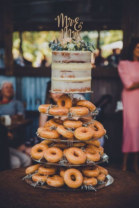 Cake With Donuts Wedding, Cake And Doughnuts Wedding, Doughnut Wedding Cakes, Rustic Donut Cake Wedding Ideas, Donut Cakes Wedding, Wedding Cake With Donuts Around, Krispy Kreme Wedding Cake Donut Tower, Donuts Wedding Cake, Wedding Doughnut Cake