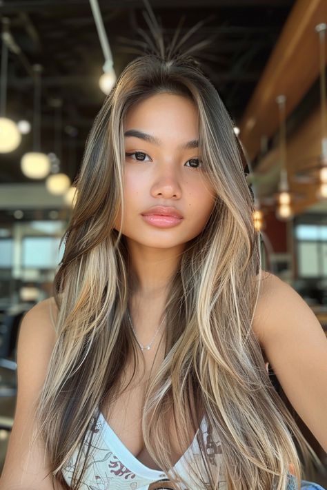 Woman with long, highlighted hair sitting indoors, looking at the camera. Dark Hair And Blonde, Dark Hair With Blonde Highlights, Dark Hair With Blonde, Blonde Chunks, Soft Blonde Highlights, Chunky Blonde Highlights, Dark Chocolate Brown Hair, Hair With Blonde Highlights, Subtle Blonde Highlights