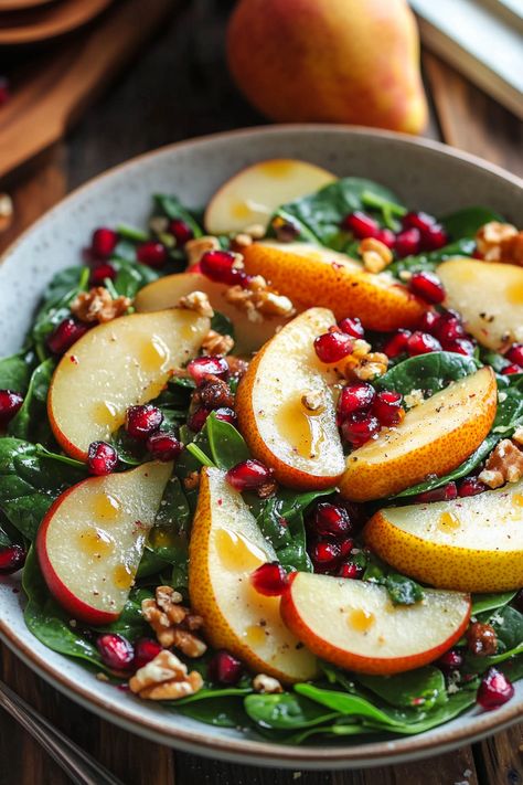 Delicious Pear and Pomegranate Spinach Salad Pear Spinach Salad Recipes, Pear Pomegranate Spinach Salad, Pear And Spinach Salad, Avocado Pomegranate Salad, Fennel Pear Salad, Spinach And Pear Salad Recipes, Pear And Feta Salad Recipes, Lemon Spinach Salad, Winter Pear Salad Recipes