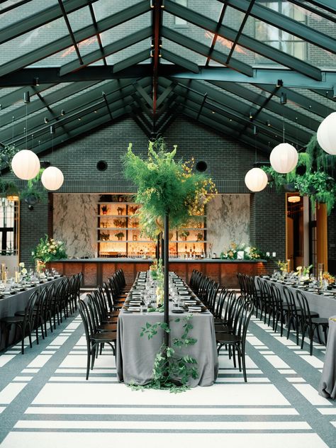 Wedding tables with grey linen, tall overhead greenery installations. Estate table with black chairs, modern floral design. Hanging wedding florals.   Wedding Planner: Ann Travis Events Photographer: The Fourniers  Detroit Wedding Venue: Shinola Hotel Shinola Hotel Wedding, Table With Black Chairs, Shinola Hotel, Black Chairs, Modern Floral Design, Florals Wedding, Wedding Venue Decorations, Venue Decor, Grand Rapids Michigan