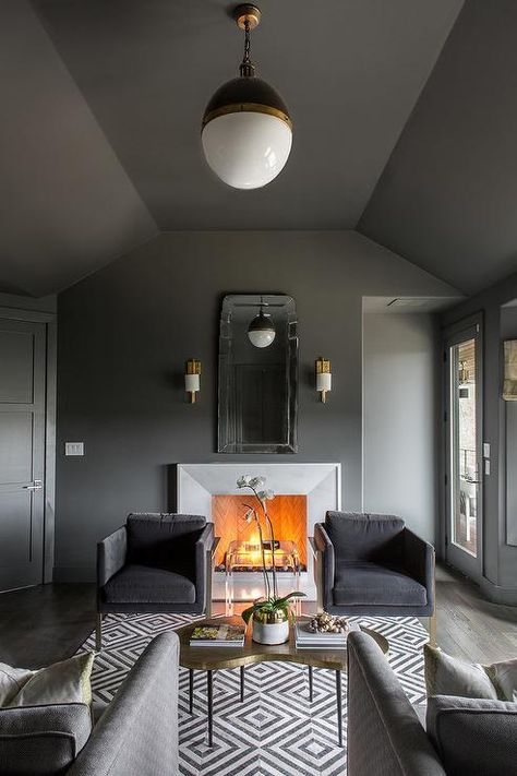 Gorgeous masculine gray den is lit by a Small Hicks Pendant hung from a charcoal gray ceiling painted in Benjamin Moore Kendall Charcoal over a gold kidney shaped coffee table placed on a white and black geometric rug. Grey Ceiling Paint, Dark Grey Room, Outdoor Dining Decor, Perfect Grey Paint Color, Monochromatic Living Room, Home Ideas Kitchen, Perfect Grey Paint, Dark Grey Rooms, Kendall Charcoal