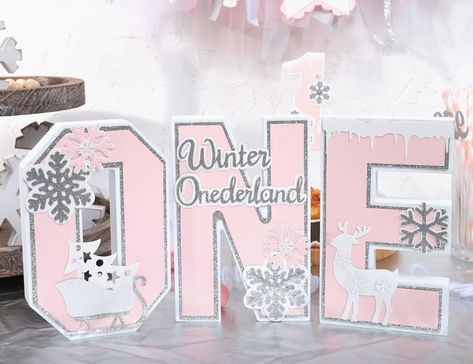 PRICES MAY VARY. wood PERFECT ACCESSORY FOR WINTER ONDERLAND BIRTHDAY - Transform your baby's first birthday celebration into a Winter Onederland wonder with our Snowflake One Letter Sign. This charming decoration is crafted in the shape of the Letter one, adorned with delicate pink and silver snowflakes, white shining sled and cute deer, creating a whimsical focal point for your winter-themed celebration. WINTER FIRST BIRTHDAY PHOTO PROP - Capture adorable memories with our Snowflake One Letter Winter Onederland Party Girl Decoration, Winter Onderland Birthday, Winter Onederland Party Girl, Winter 1st Birthday, Birthday Table Decor, 1st Birthday Decoration, Snowflake Birthday Party, First Birthday Winter, Winter Wonderland Birthday Party