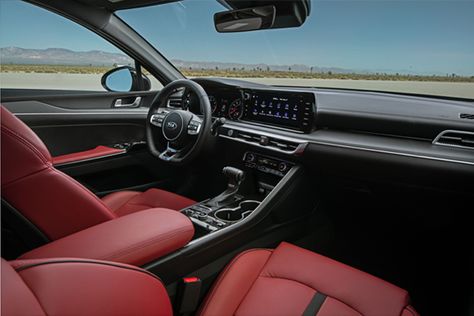 The all-new 2021 Kia K5 offers a mix of premium and sporty upholstery options including red leatherette seating, satin chrome metallic and wood-like finishes on the dashboard and door panels (depending on trim). Kia K5 Gt Line, K5 Gt Line, Red Interior Car, Car Stunt, Mid Size Sedan, Kia K5, Kia Stinger, Luxury Vehicles, Driving Games