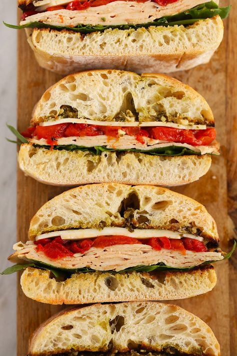 Forget the subway party platter and make this Grilled Roasted Red Pepper, Pesto, & Turkey sandwich! It is perfectly toasted on the grill and a great meal for the family or a larger group at a bbq! Sandwich With Roasted Red Pepper, Turkey Roasted Red Pepper Sandwich, Peppered Turkey Sandwich, Roasted Red Pepper Pesto Chicken Sandwich, Roasted Red Pepper Wrap, Roasted Turkey Sandwich, Deli Turkey Sandwich, Roasted Red Pepper Sandwich, Turkey Pesto Sandwich