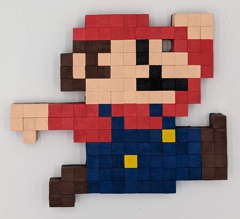 "Check out this awesome 8-bit Retro Jumping Mario from Super Mario Bros, crafted with care from solid hardwood. It's a nostalgic pixel art masterpiece, meticulously assembled from individually cut wooden pieces that were painted and placed on a 1/4\" board to create this cool gaming decor item. Whether you want to spruce up your game room, add some flair to your workspace, liven up a kid's room, or just enhance your home's vibe, this piece is a fantastic choice. You can hang it on the wall using the included sawtooth hanger, or let it stand alone as a striking figure. The pixels here aren't just flat; they've got varying grain and colors to capture the character's iconic look. It's the perfect blend of nostalgia and craftsmanship, and it's ready to be a standout feature in your space. ⚠️ T Pixel Art Wall, 8 Bit Pixel Art, Jumping Poses, Pokemon Room, Geeky Craft, 8 Bit Art, Pixel Characters, Gaming Tattoo, Pixel Art Games