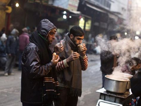 People drink tea at a roadside tea stall - North India shivers in extreme cold | The Economic Times Weather In India, Shopping Meme, Backpacking India, Human Figure Sketches, India Culture, India Food, Vegetarian Restaurant, North India, Economic Times