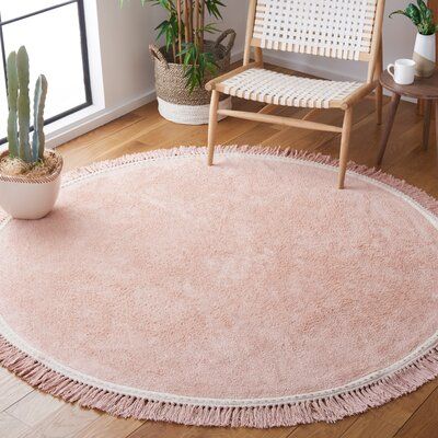 This indoor area rug features a round silhouette and a plush-looking pile to give your space a traditional look. Pink and ivory tones come together for a vibrant foundation with a standout tasseled border. This rug makes it ideal for most areas around your home like your living room or dining room. It's also safe to use on heated floors. Even though it has a backing, we recommend pairing it with a rug pad (sold separately) to keep everything in place. Rug Size: Round 3' | White 36 x 36 x 0.39 in Solid Area Rugs, Pink Ivory, Cotton Area Rug, Heated Floors, Pink Area Rug, Nursery Rugs, Classic Rugs, Round Area Rugs, Ivory Rug