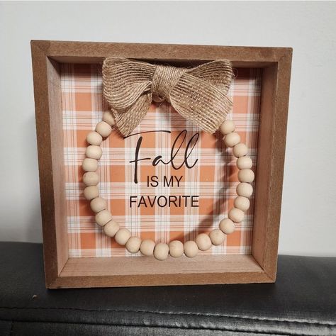 Welcome Your Guests This Fall With Our Way To Celebrate Harvest Fall Ls My Favorite Tabletop Shadowbox Sign. This Seasonal Sign Has An Orange Plaid Background With "Fall Ls My Favorite" Printed In Black Lettering. The Lettering Is Encircled With A Wreath Made Of Light Orange Wooden Beads And Topped Off With A Twine Ribbon Bow. A Perfect Addition To Your Thanksgiving Party Or Autumn Decor, It's A Great Decoration For Your Home, Classroom, Office, And More. Coordinate This Autumn Decoration With O Fall Decor Diy Crafts, Fall Frames, Home Classroom, Thanksgiving Harvest, Plaid Background, Skeleton Decorations, Autumn Decoration, Diy Thanksgiving, Thanksgiving Party