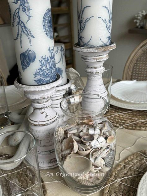 Father's Day is just around the corner, and what better way to celebrate than with delightful coastal table decor! Decorate Candles, Coastal Table Decor, Decoupage Candles, Ivory Pillar Candles, Coastal Table, Blue And White Living Room, Vintage Flower Pots, White Candle Sticks, Inexpensive Decor