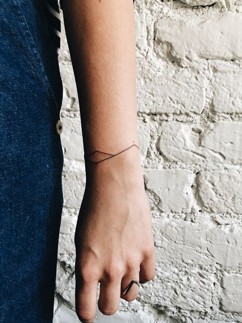 handpoke mountains Mountain Tattoo Bracelet, Spectrum Tattoo Design, Abstract Bracelet Tattoo, Mountain Bracelet Tattoo, Mountain Armband Tattoo, Braclet Tattoo, Line Tattoo Arm, Wrap Around Wrist Tattoos, Lilac Tattoo