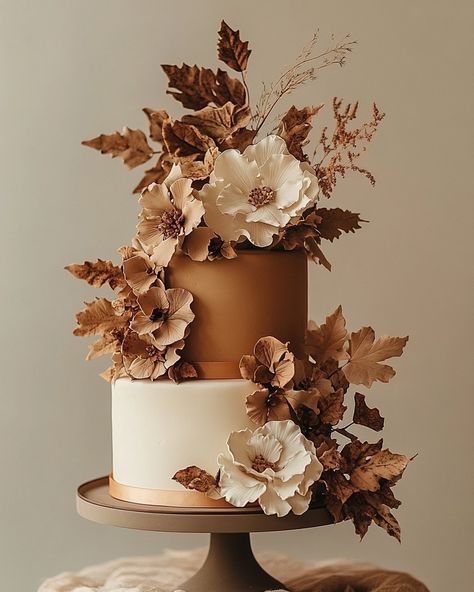 Celebrate the beauty of the fall season with this enchanting autumn-inspired wedding cake. Featuring rich, earthy tones of burnt orange, copper, and cream, this two-tiered masterpiece is adorned with delicate sugar flowers and foliage that perfectly capture the essence of the season. The textured leaves and flowers create a stunning contrast against the smooth fondant finish, making this cake a perfect centerpiece for rustic or nature-inspired weddings. Embrace the warmth and charm of autumn ... Gluten Free Wine, Brown Wedding Cakes, Autumn Wedding Cake, Rustic Autumn Wedding, Autumn Wedding Cakes, Lo Mein Noodles, Enchanting Wedding, Earthy Wedding, Orange Copper