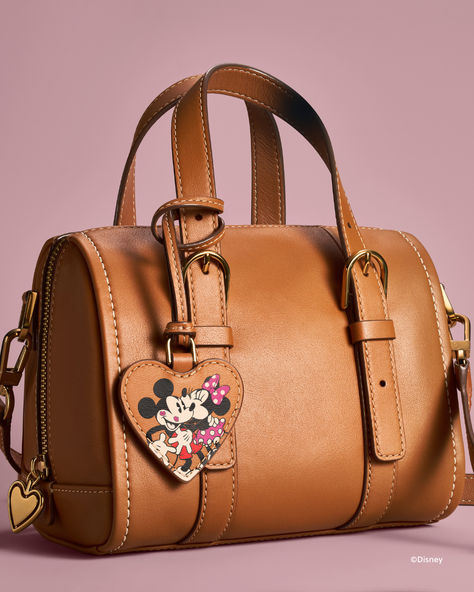 Find the wonder in every moment with the Disney Fossil collection. This special-edition mini satchel features one slide pocket, one zipper pocket, an adjustable and detachable crossbody strap with two handles, brown leather with contrast stitching and Disney's Mickey Mouse and Minnie Mouse. The perfect Valentine's Day gift for the ultimate Disney fan! Fossil Collection, Mickey Mouse Purse, Cozy Things, Mickey Mouse And Minnie Mouse, Disney Purse, Disney Day, Cute Handbags, Disney Fan, Disney Stuff