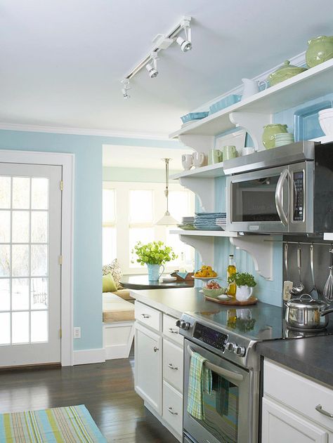 French Connection     Replacing a window at the end of the kitchen with a new, energy-efficient French door provides easy access to outside. This functional and charming white door adds natural light into the room and helps carry out the kitchen's color scheme of Tiffany blue and cream, which was selected to help play up the home's cottage roots Blue Kitchen Walls, Small Cottage Kitchen, Budget Kitchen Remodel, Kitchen Walls, House Of Turquoise, Kitchen Transformation, Kitchen Colour Schemes, Pretty Kitchen, Kitchen Display