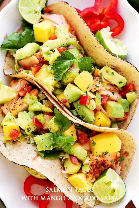 Salmon Tacos with Mango Avocado Salsa - Healthy, deliciously seasoned salmon tacos topped with an amazing mango avocado salsa and a cilantro-yogurt sauce. Mango Tacos, Salmon Tacos Recipe, Mango Salmon, Seasoned Salmon, Garlic Butter Salmon, Salmon Tacos, Mango Avocado Salsa, Salmon Fillet, Mango Avocado