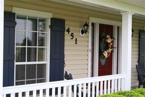 exterior tan house with blue shutters Navy Shutters, Paint Colors For House, Colors For House, Tan House, Shutter Colors, Best Exterior Paint, House Paint Color Combination, Black Shutters, House Shutters