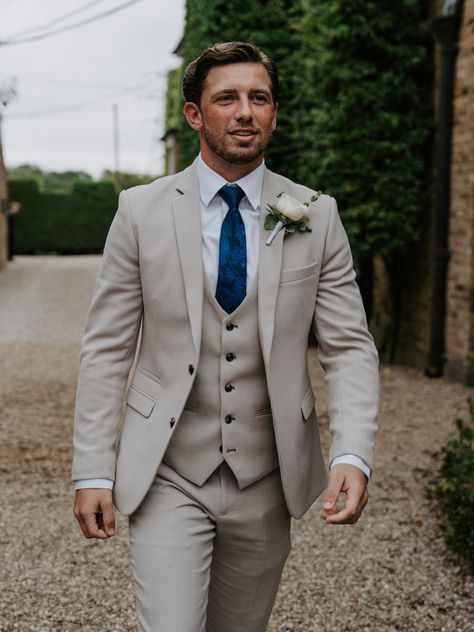 Groom with dark brown swept hair wearing three piece light grey wedding suit with dark blue wedding tie and white rose buttonhole accessory | groom style | groom suit | wedding fashion | Joshua Andrew Potter Groom Suit With Suspenders, Light Groom Suit, Spring Wedding Suits Groom, Gray Suits For Men Wedding, Gray Suit Groom, Light Grey Wedding Suit, Light Grey Groomsmen, Best Wedding Suits For Groom, Best Man Suit Wedding