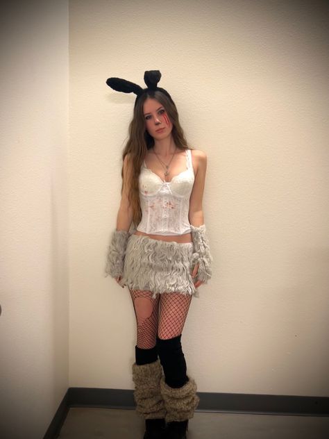 a girl wearing a frank the rabbit from donnie darko halloween costume consisting of fur leg and arm warmers, a fur skirt, a white corset top, fishnets, and black rabbit ears. Frank The Rabbit Costume, Donny Darko Costume, Frank The Bunny Costume, 2014 Halloween Costumes, Donnie Darko Makeup, Donnie Darko Couple Costume, Frank Donnie Darko Costume, Donnie Darko Halloween Costume, Donnie Darko Halloween