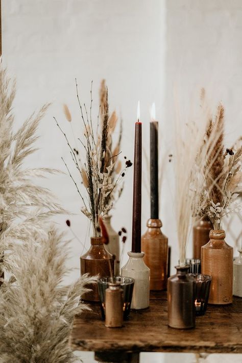 Industrial Boho Wedding Styling at The Winding House with Pampas Grass Installation | Rock My Wedding | Bloglovin’ Dried Grass Table Decor, How To Style Round Table, Candles In Bottles Wedding, Dry Grass Wedding Decor, Boho Wedding Floral Decor, Center Of Kitchen Table Decor, Boho Candle Decor, Industrial Boho Wedding, Dried Floral Wedding