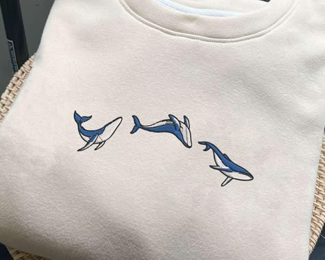 Blue Ocean Whale Embroidered Sweatshirt, Whale Shark embroidery Crewneck, Respect The Locals, Nature Lover Gifts, Save the ocean shirt This sweatshirt is crafted from high-quality cotton weave and features advanced embroidery technology to ensure vibrant colors and intricate patterns. It's unisex, soft, and comfortable, making it perfect for a stylish, casual look. Each sweatshirt boasts a unique aesthetic, making it a timeless gift for family, friends, or teachers. Size: We offer a range of col Ocean Inspired Outfits, Shark Embroidery, Whale Embroidery, Respect The Locals, Ocean Whale, Embroidery Crewneck, Save The Ocean, Ocean Shirt, Advanced Embroidery