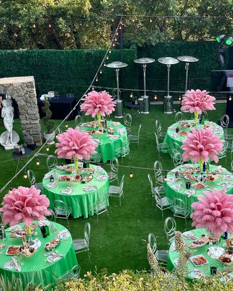 Step into a fairytale with these stunning pink ostrich feather centerpieces! Perfectly paired with vibrant green tables and clear chairs, this setup is giving us all the lush garden party vibes. 🌿💗 Whether you’re celebrating a milestone or just love a good soirée, this decor will make your event truly unforgettable. Cheers to making every moment magical! Special thank you to @events_boutique ! 🩵 • • • #tabledecor #ostrichfeathers #feathercenterpiece #rentfeathers #oldhollywood #greatgatsby... Aka Centerpieces, Pink And Green Pool Party, Lime Green Table, Lime Green And White Wedding Decor, Pink And Green Flamingo Party, Ostrich Feather Centerpieces, Pink Party Decorations, Green Centerpieces, Feather Centerpieces